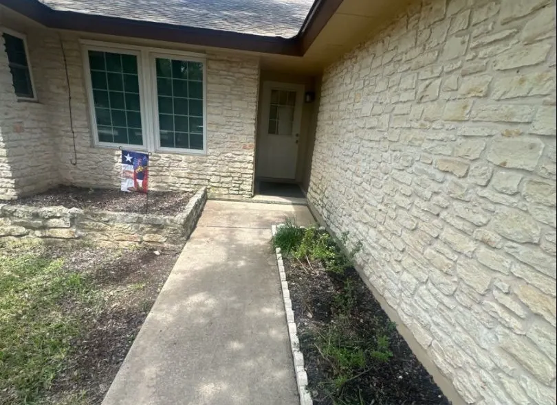 After: entry cleanup. Beds cleared and trimmed for curb appeal.