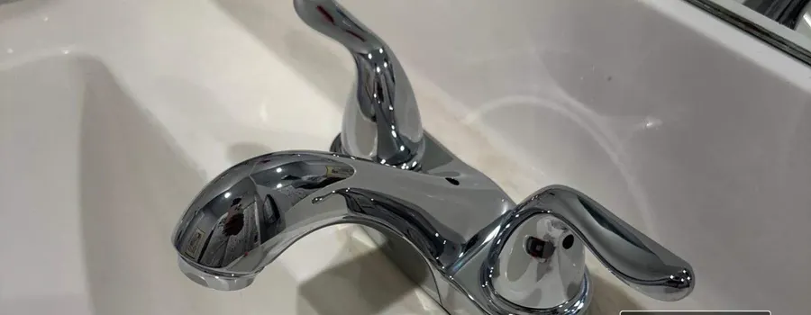 After: faucet replacement. Leaking, corroded faucet swapped for a new two-handle set.