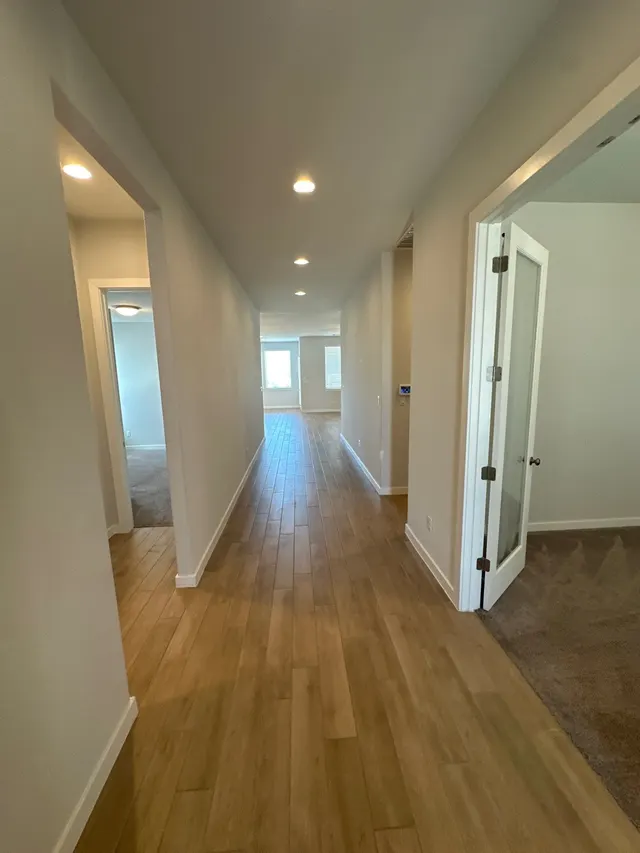 Long hallway with new wood-look vinyl plank floors and fresh paint