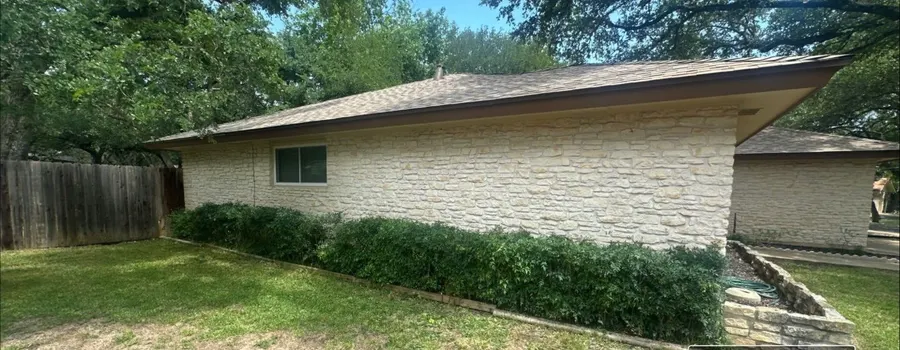After: shrub trim. Overgrown hedge cut back off the house.