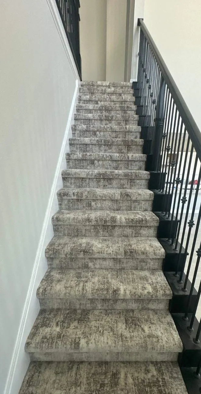 After: stair carpet install. Stripped treads to finished stairs, wrapped and tucked clean.