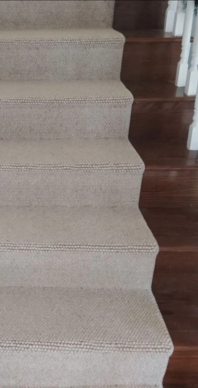 After: stair runner. Stained runner replaced with a woven runner over hardwood.